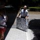 An anti-vaccine rally protester dressed up as Joe Biden holds a sign outside of Houston Methodist Hospital in Houston, Texas, in June 2021.